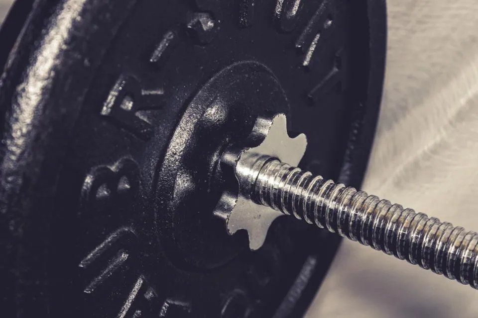 Close-up of a barbell plate being fastened